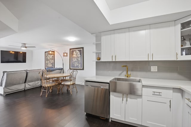 kitchen with tasteful backsplash, dishwasher, sink, and white cabinets