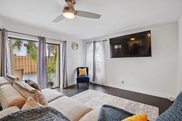 living room with dark hardwood / wood-style floors and ceiling fan