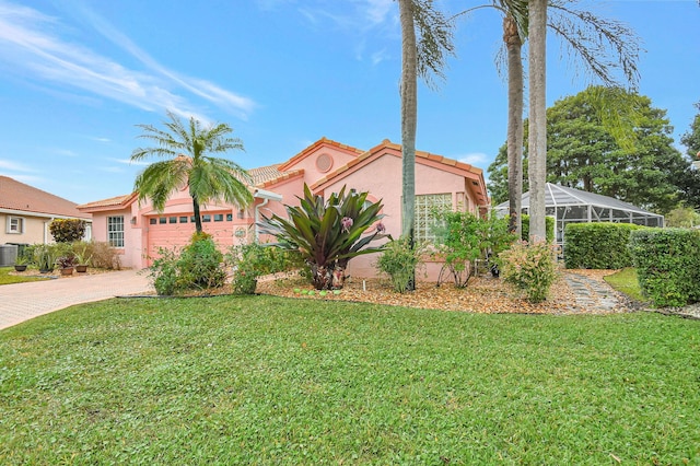 view of front of property with cooling unit, a garage, a front lawn, and glass enclosure