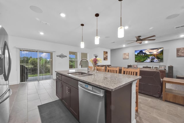 1316 SW Abacus Ave, Port Saint Lucie, FL 34953 - kitchen with appliances with stainless steel finishes, a sink, a ceiling fan, a kitchen island with sink, and pendant lighting
