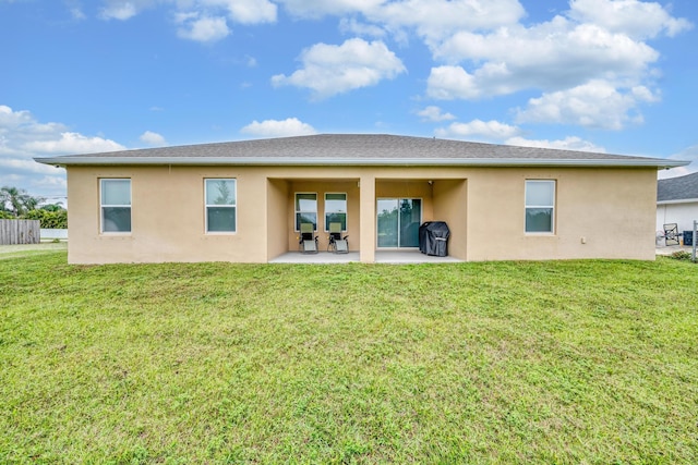 1316 SW Abacus Ave, Port Saint Lucie, FL 34953 - rear view of property featuring stucco siding, a patio, and a lawn