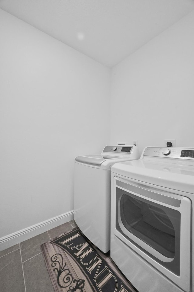 1316 SW Abacus Ave, Port Saint Lucie, FL 34953 - washroom featuring washing machine and dryer, baseboards, and tile patterned floors