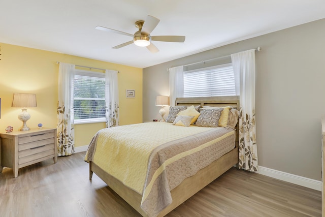 bedroom with hardwood / wood-style flooring and ceiling fan