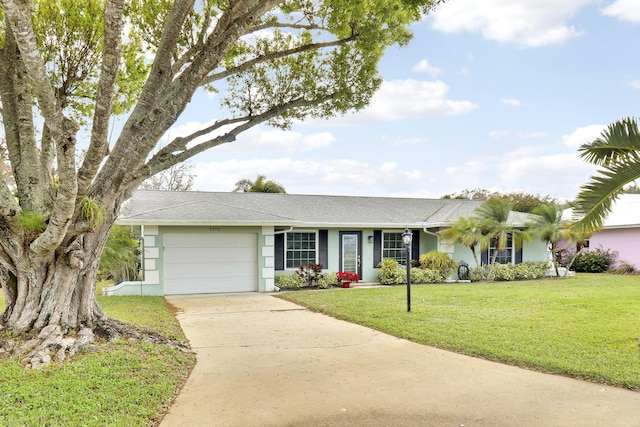 ranch-style house featuring a garage and a front lawn