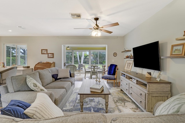 living room featuring plenty of natural light and ceiling fan