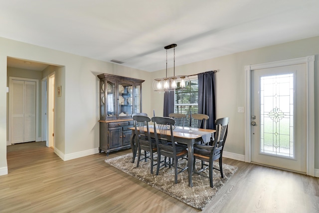 dining space with light hardwood / wood-style floors