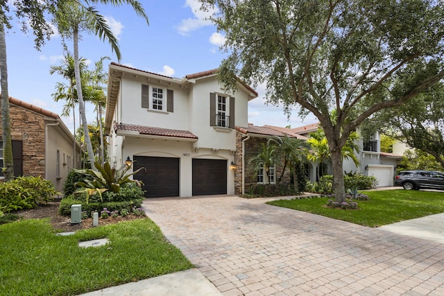 mediterranean / spanish-style home featuring a garage and a front lawn