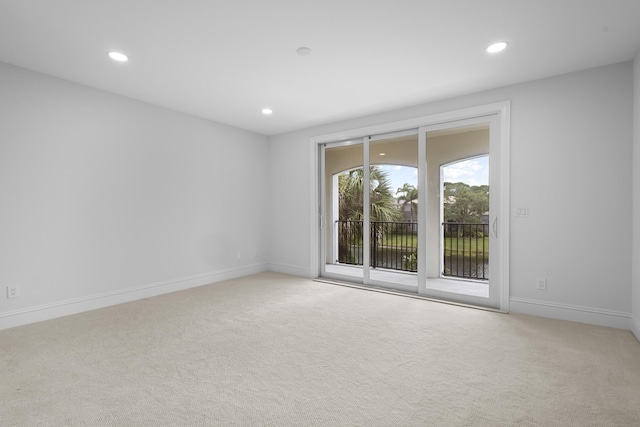 spare room featuring light colored carpet