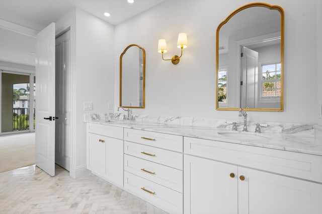 bathroom featuring parquet floors and vanity