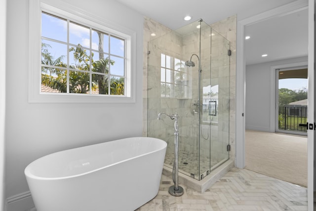 bathroom with plenty of natural light and independent shower and bath