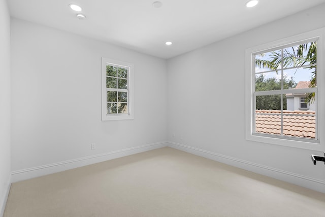 unfurnished room featuring plenty of natural light and carpet flooring