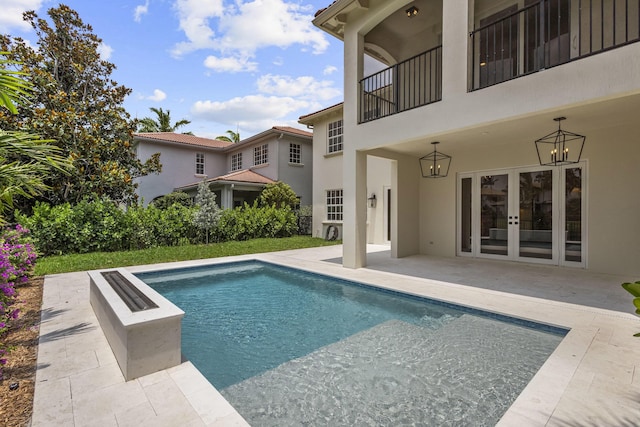 view of pool featuring a patio area and french doors