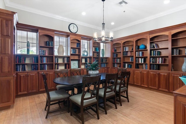 dining space with crown molding and light hardwood / wood-style flooring