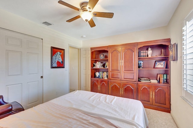 bedroom featuring a ceiling fan, a closet, multiple windows, and visible vents