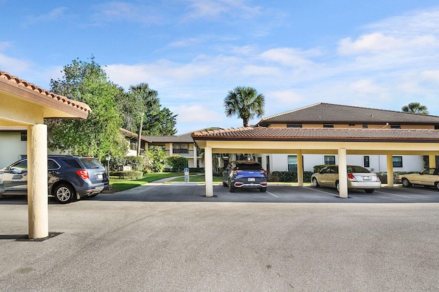 view of parking / parking lot featuring a carport