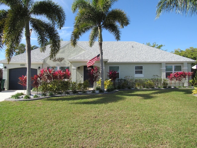 view of front of property with a garage and a front yard