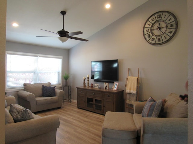 living room with lofted ceiling, light hardwood / wood-style floors, and ceiling fan