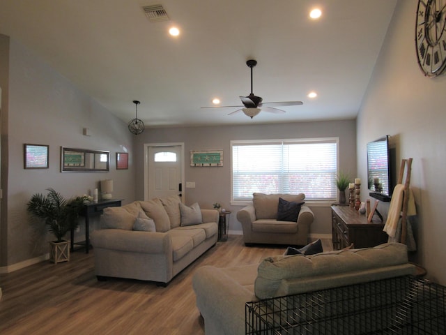 living room featuring ceiling fan, vaulted ceiling, and wood-type flooring