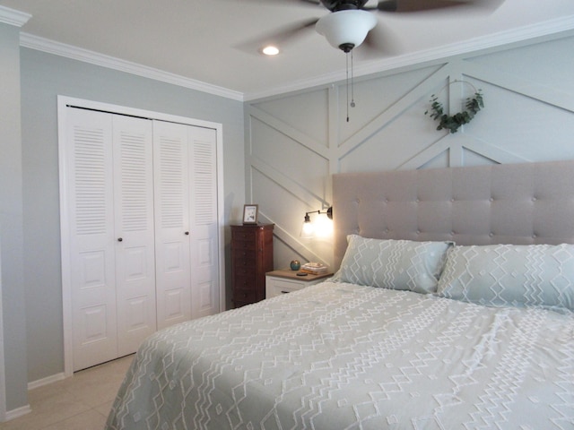 tiled bedroom with crown molding, a closet, and ceiling fan