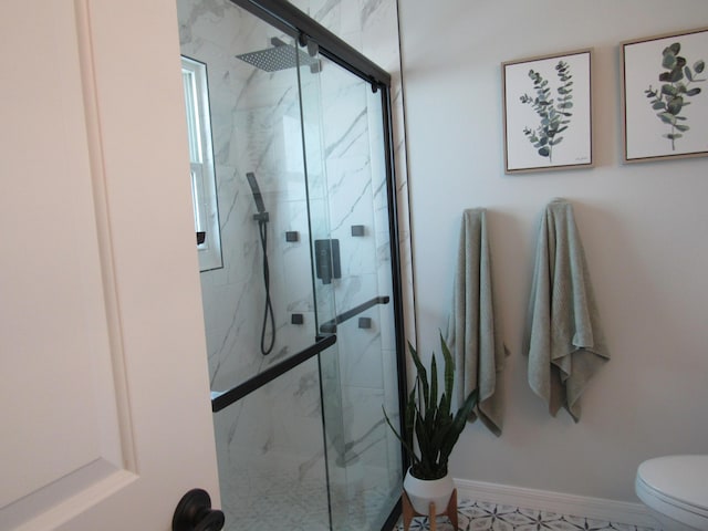 bathroom with toilet and an enclosed shower