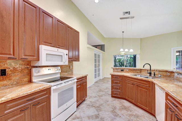 kitchen with sink, pendant lighting, white appliances, light stone countertops, and decorative backsplash