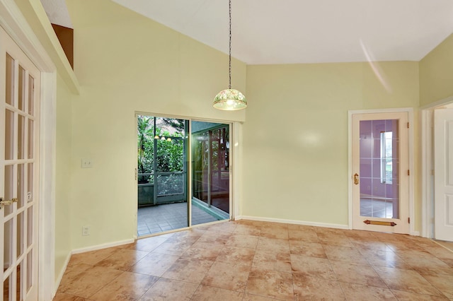 unfurnished dining area featuring a high ceiling and light tile patterned floors