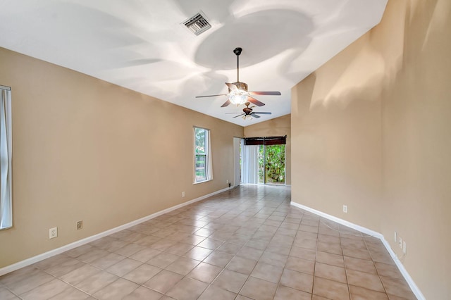 tiled spare room featuring vaulted ceiling and ceiling fan