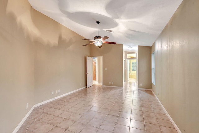 tiled spare room with lofted ceiling and ceiling fan