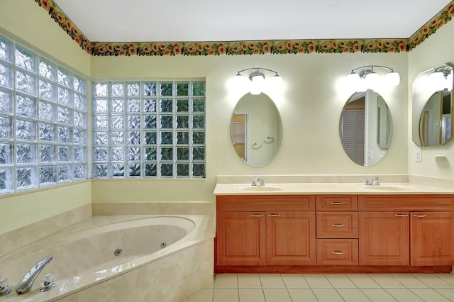 bathroom featuring vanity, tile patterned floors, and a bathing tub