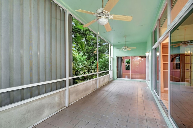 unfurnished sunroom featuring ceiling fan