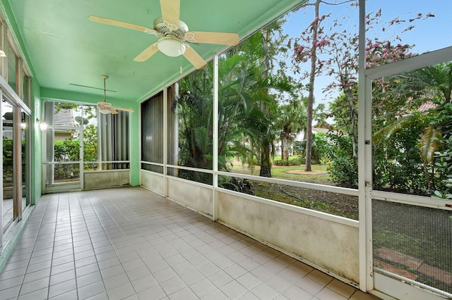 unfurnished sunroom featuring ceiling fan