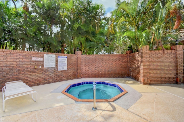 view of pool featuring a community hot tub and a patio area