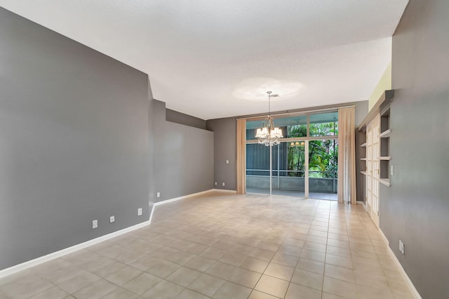 empty room featuring light tile patterned flooring, expansive windows, and a notable chandelier