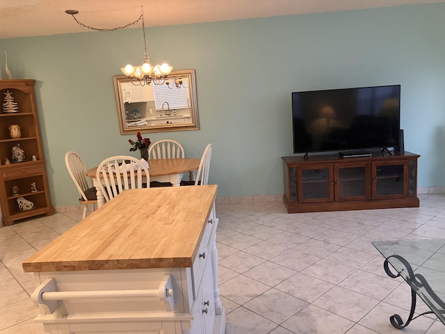 tiled dining area with sink and a chandelier