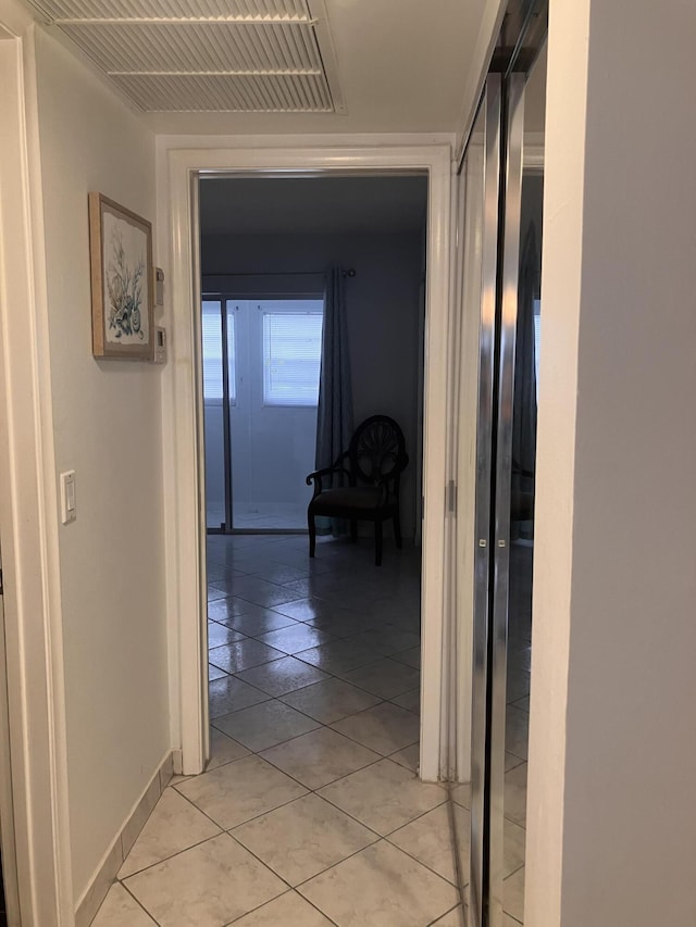 corridor with light tile patterned floors