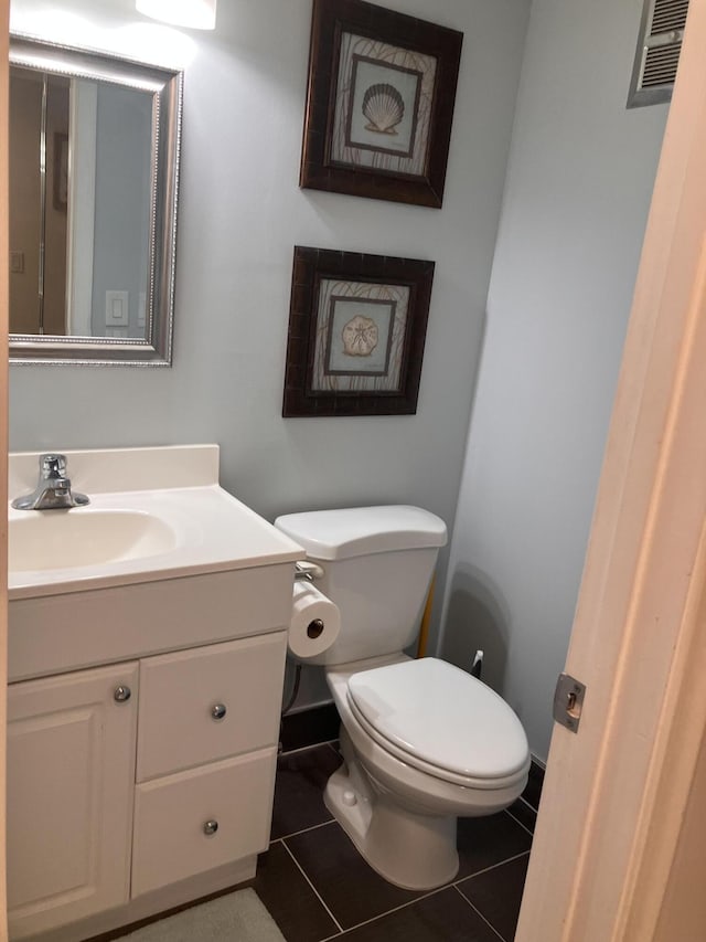 bathroom featuring tile patterned floors, toilet, and vanity