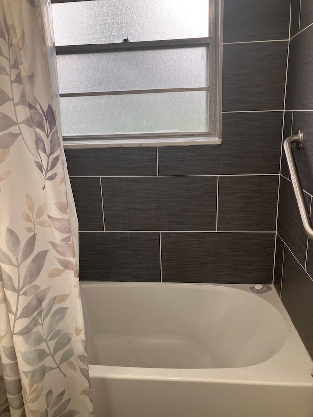 bathroom featuring shower / tub combo with curtain