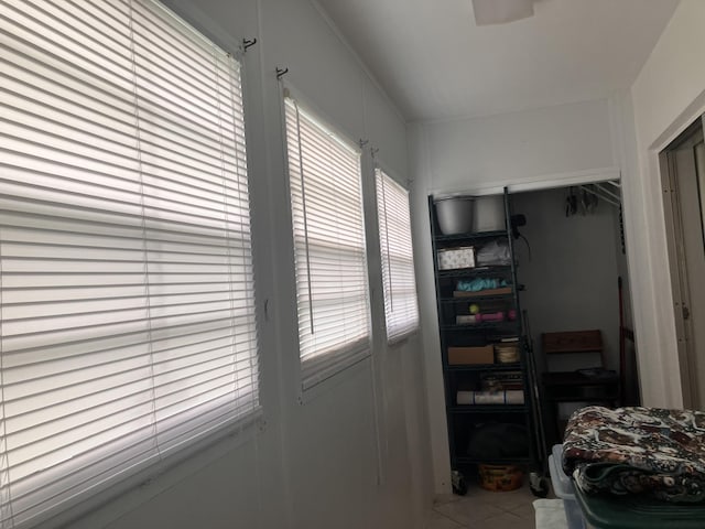 tiled bedroom with multiple windows