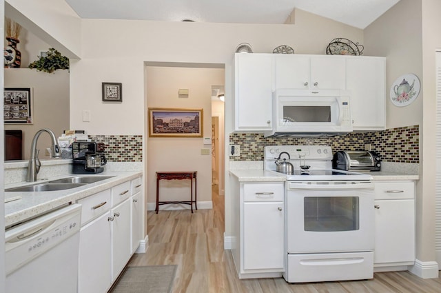 kitchen featuring white cabinetry, sink, white appliances, and decorative backsplash