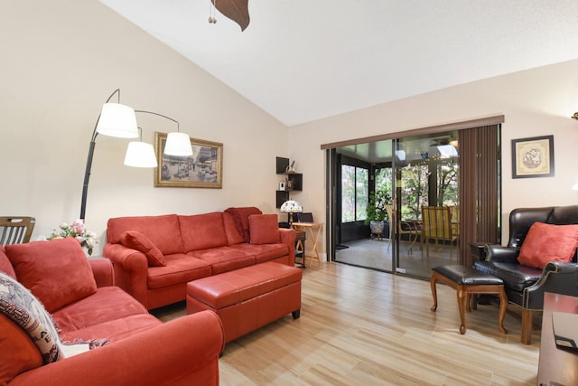 living room featuring vaulted ceiling, light hardwood / wood-style floors, and ceiling fan