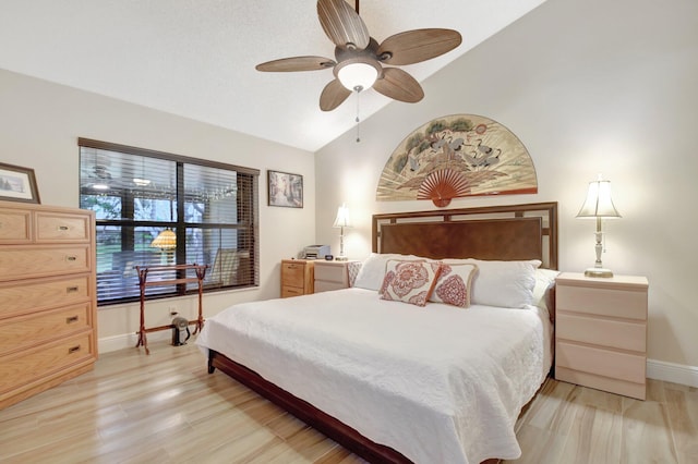 bedroom featuring lofted ceiling, ceiling fan, and light hardwood / wood-style flooring