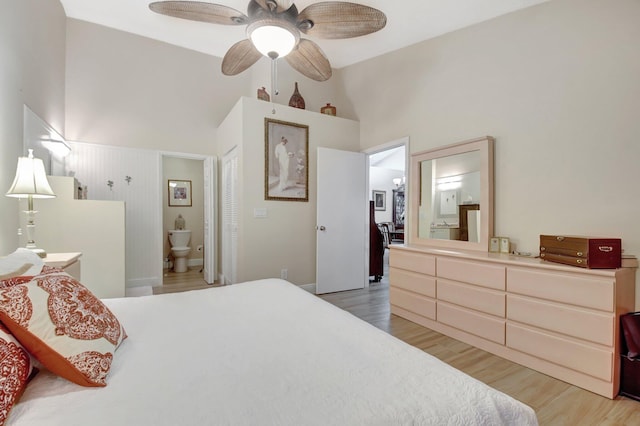 bedroom with lofted ceiling, hardwood / wood-style floors, ceiling fan, and ensuite bathroom