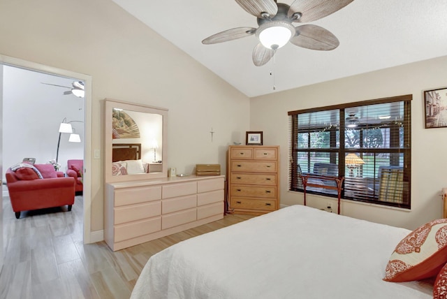 bedroom with ceiling fan, lofted ceiling, and light hardwood / wood-style flooring