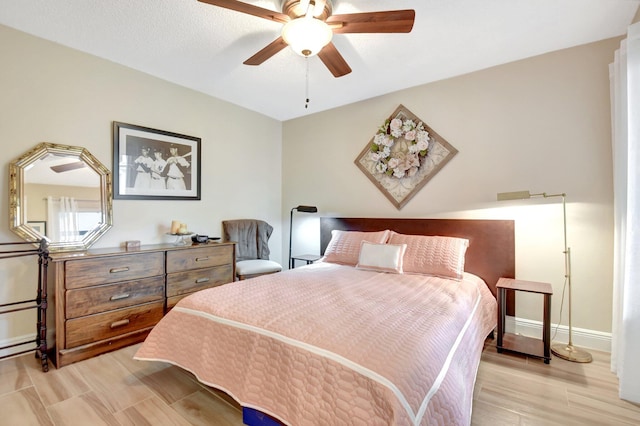 bedroom with ceiling fan and light hardwood / wood-style flooring