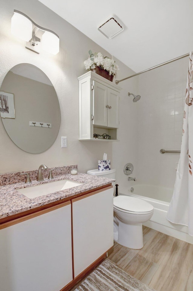 full bathroom with vanity, shower / tub combo, hardwood / wood-style flooring, and toilet