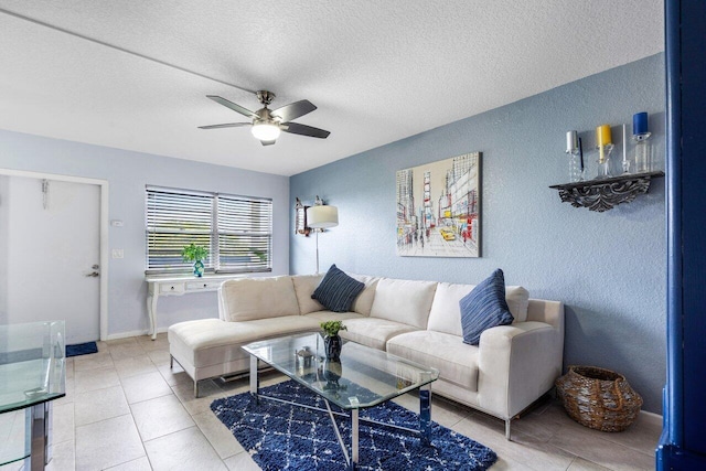 living room featuring tile patterned flooring, a textured ceiling, and ceiling fan