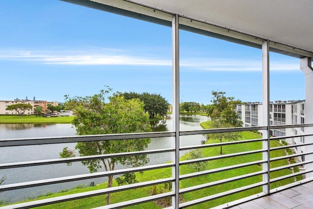 unfurnished sunroom with a water view