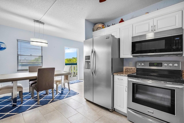 kitchen with stainless steel appliances, hanging light fixtures, white cabinets, and a textured ceiling