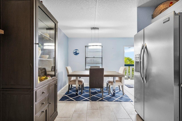 dining space featuring a textured ceiling