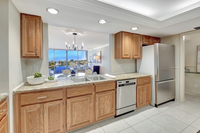 kitchen featuring sink, crown molding, light stone counters, pendant lighting, and stainless steel appliances